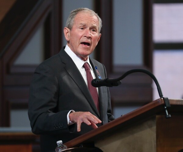 george w. bush speaking at a lectern