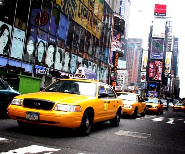 Taxis driving through Times Square in NYC.