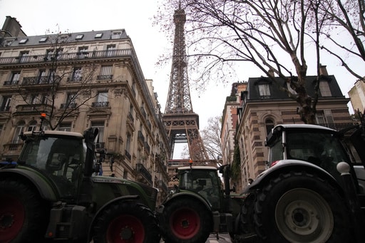 Farmers Drive Tractors through Paris and Block Highways in Greece to Protest Free Trade Deal