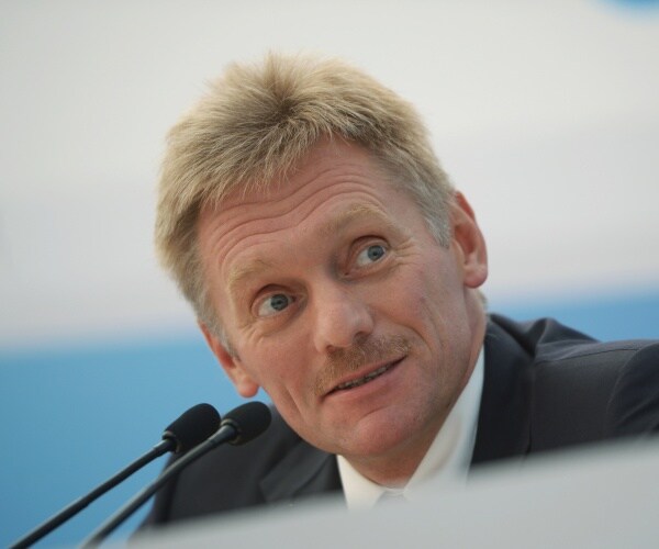 dmitry peskov speaks into a microphone
