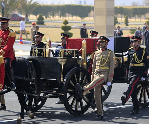 egyptian honor guards escort the casket of former president hosni mubarak