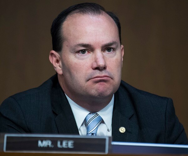mike lee listens to others speak at a committee meeting