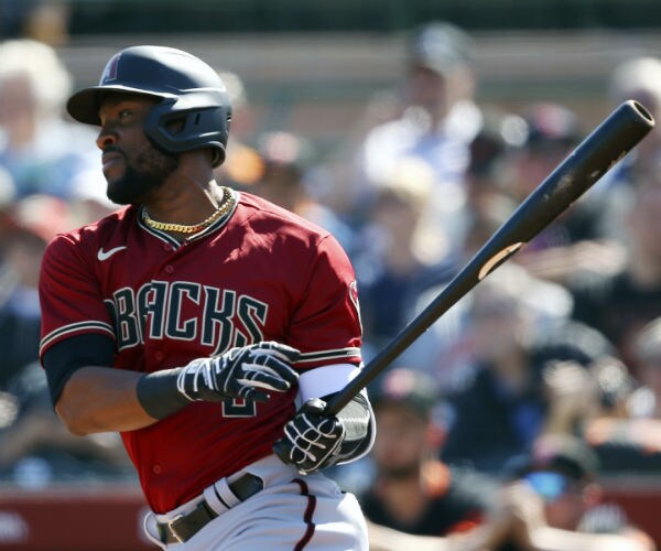 starling marte takes a swing with his bat during a game in his arizona diamondback uniform