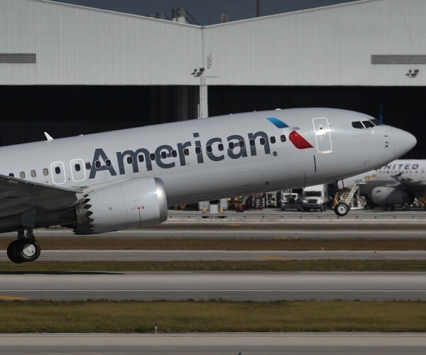 american airlines plane takes off from an airport