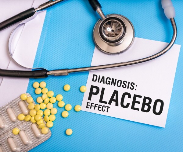 "Diagnosis: Placebo Effect" written on paper, pills, stethoscope 