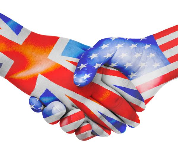 people shanking hands with the hands painted as the british and american flags