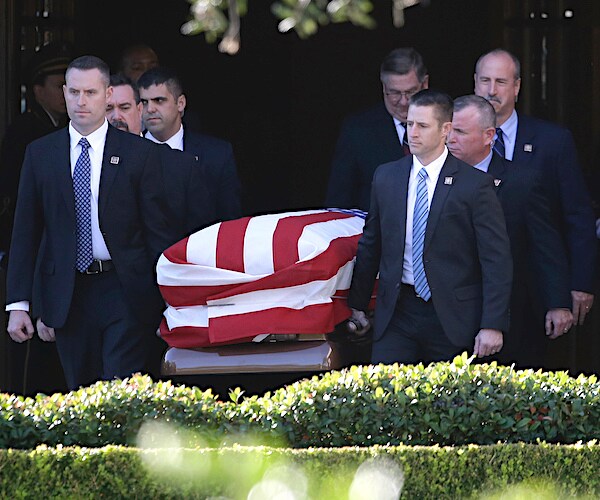 secret service agents carry former president george h.w. bush to a hearse after a family service in houston