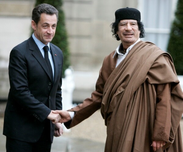 nicolas sarkozy greets libyan leader col. moammar gadhafi
