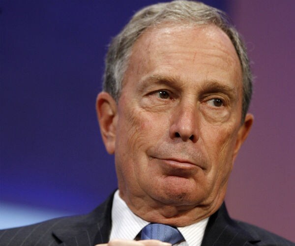 mike bloomberg is shown in dress shirt, suit and blue tie