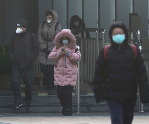 people in beijing head to work on february 10 wearing protective face masks