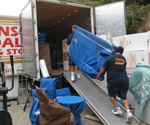 workers move furniture