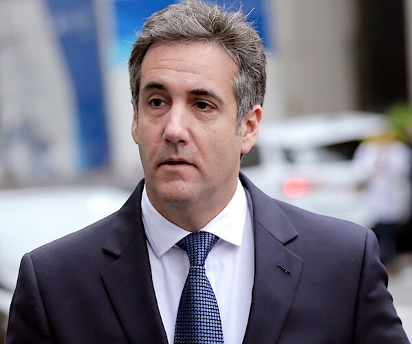 michael cohen stands outside of a new york city office building