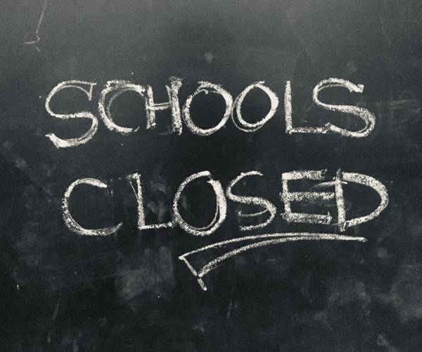the words schools closed written on a blackboard