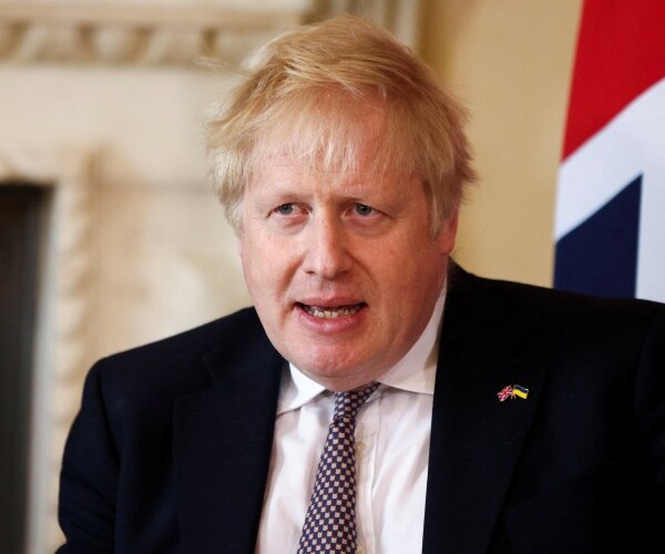 boris johnson speaks during a meeting