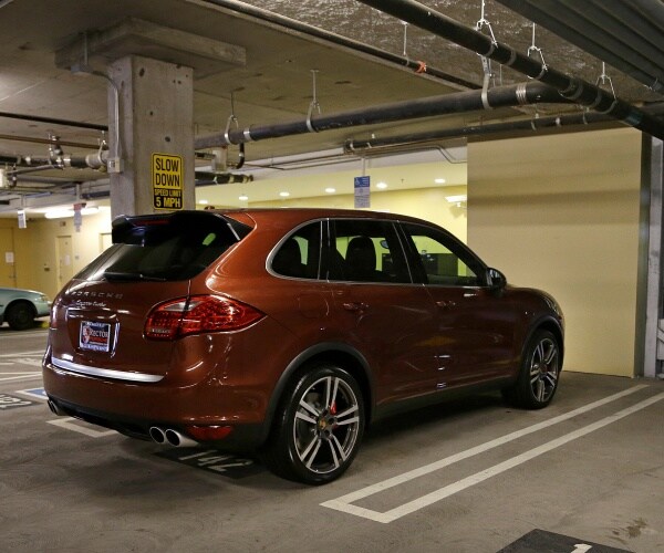 orange-brown suv parked inside a parking garage