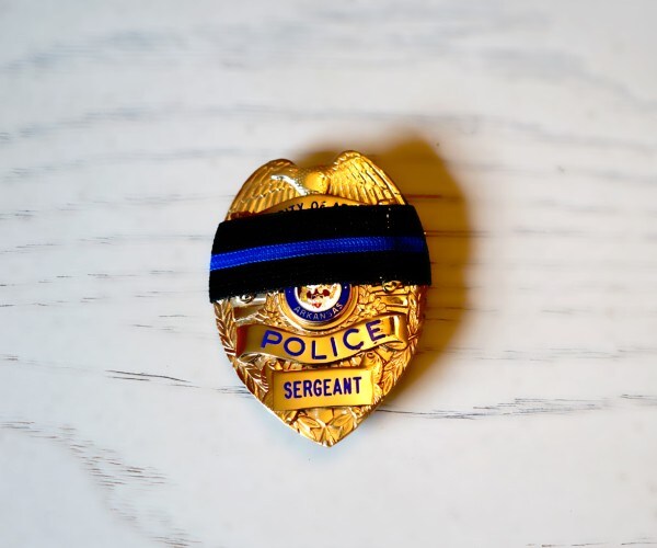 mourning band on police badge 