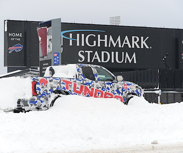 highmark stadium in buffalo with a truck stranded and buried in snow