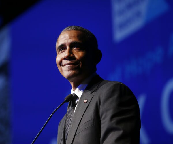 barack obama is shown at a podium 