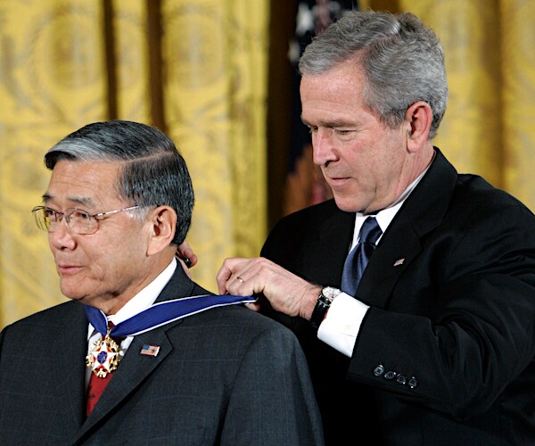 norman mineta receives a presidential medal from george w. bush