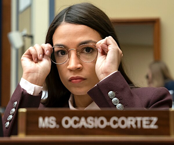 Alexandria Ocasio-Cortez adjusts her glasses during a house committee meeting