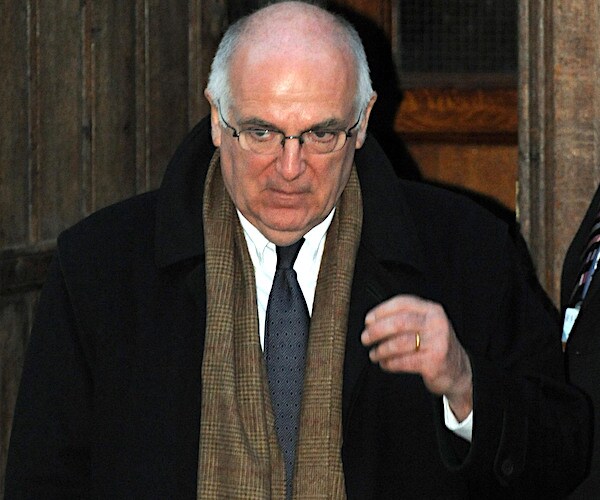 sir richard dearlove looks down as he leaves a building in london and is about to enter a black vehicle