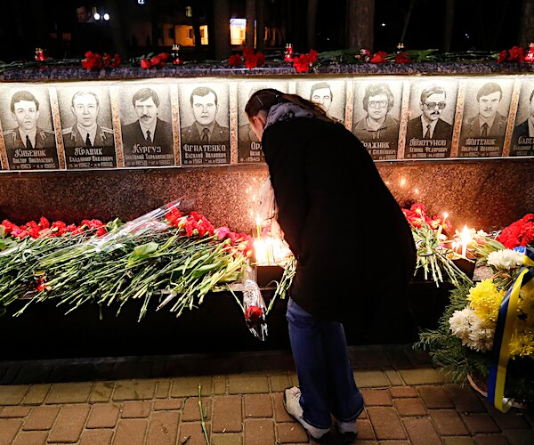 A Ukrainian lights candles to commemorate those who died after the 1986 Chernobyl nuclear disaster