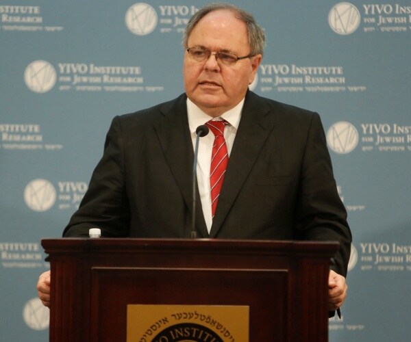 dani dayan speaks from a podium