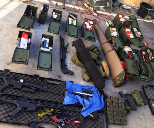 assault rifles and lots of ammunition are shown