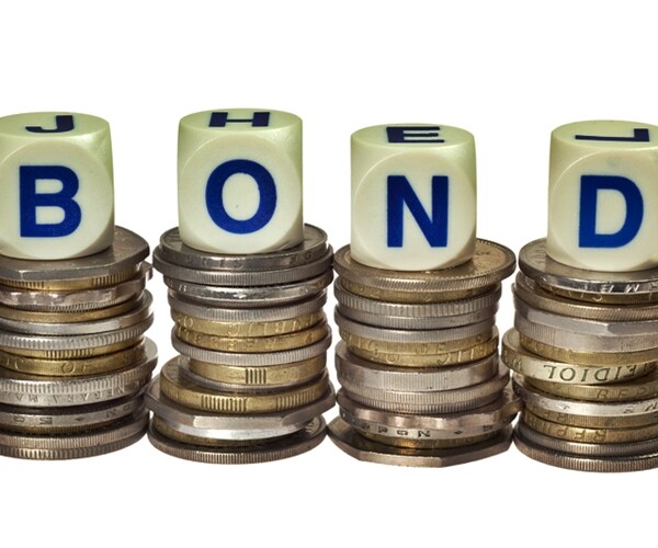 stacks of coins with the word bond isolated on white background 