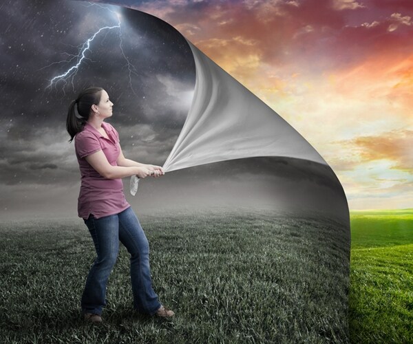 woman pulls pack page and reveals sunset. 