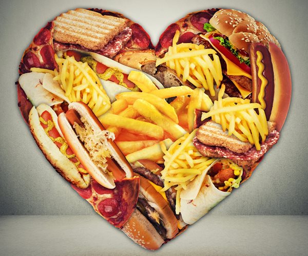 a heart shape filled with french fries, breads, and hot dogs