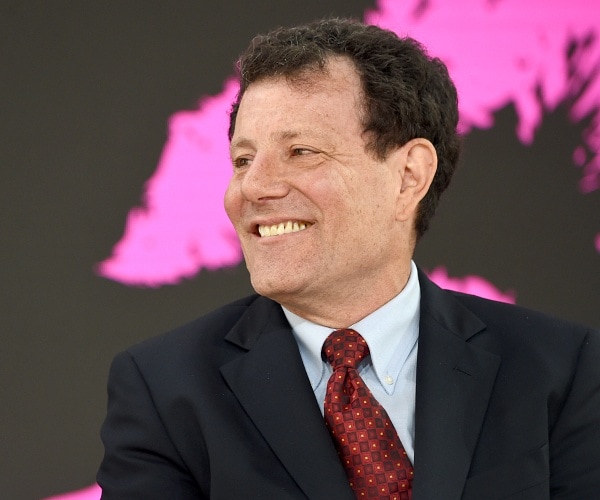 nicholas kristof sits in chair onstage