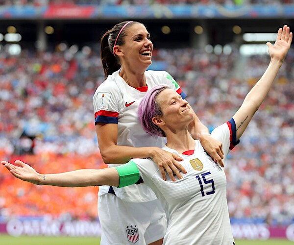 alex morgan jumps on the back of megan rapinoe after the deciding goal in the world cup final
