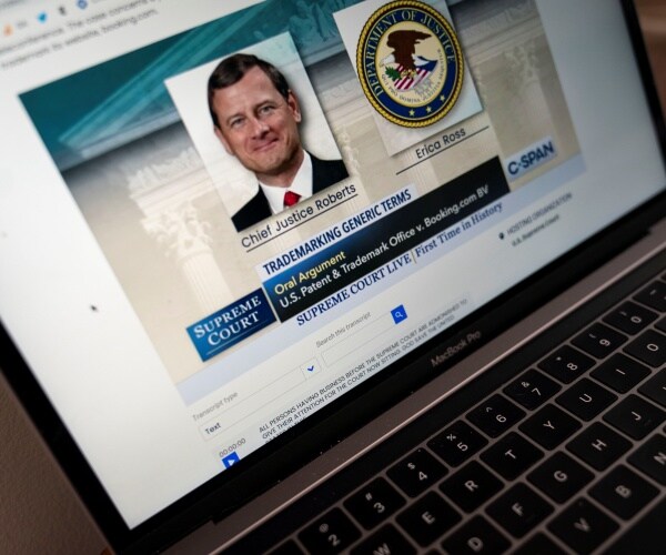 laptop showing a picture of justice roberts making an oral argument