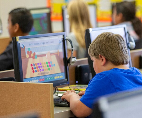 Elementary school students work on computers in Utah