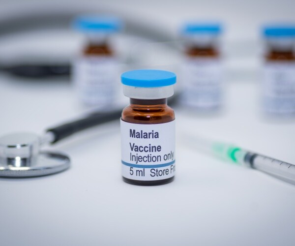 vial labeled 'malaria vaccine' with syringe
