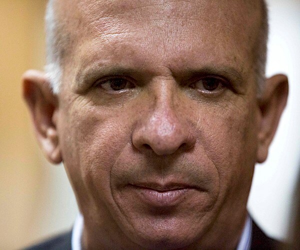 hugo carvajal, a congressman in venezuela's governing socialist party, listens to a reporter's question