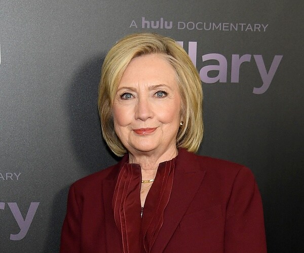 hilary clinton poses for photo