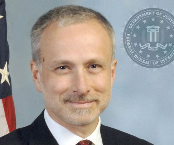 james baker is shown in doj pic with logo in background