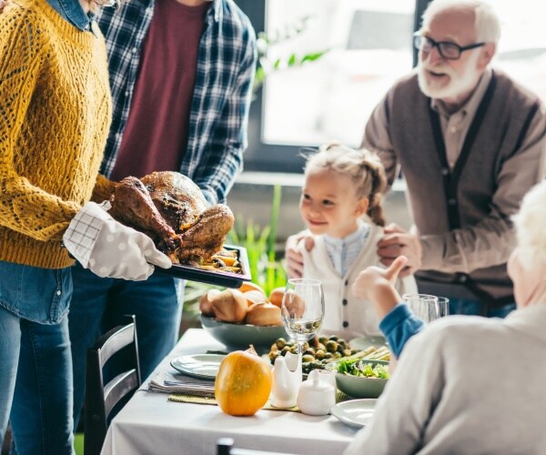 thanksgiving dinner with a family sitting at the table