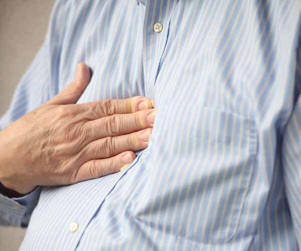 man suffering from chest discomfort