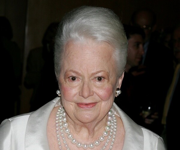 olivia de havilland wearing a white dress with pearl necklaces and earrings