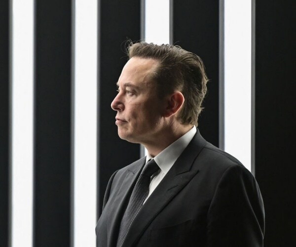 tesla ceo elon musk in black and white is pictured with black and white background