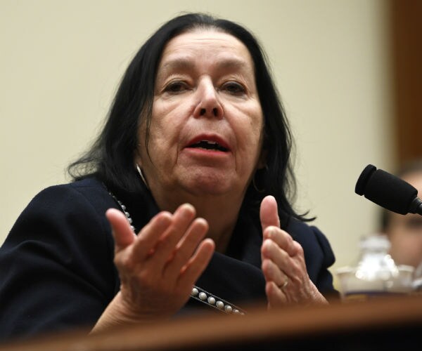 Christine Levinson, wife of Robert Levinson, gestures with her hands as she testifies on capitol hill