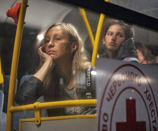 evacuees from mariupol arrive on buses at a registration and processing area