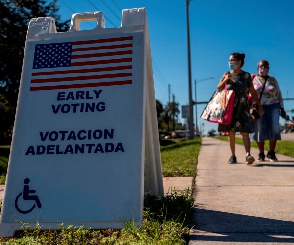 two women walk to florida polling place