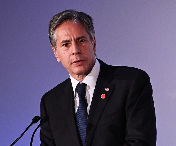 antony blinken speaks into podium mic