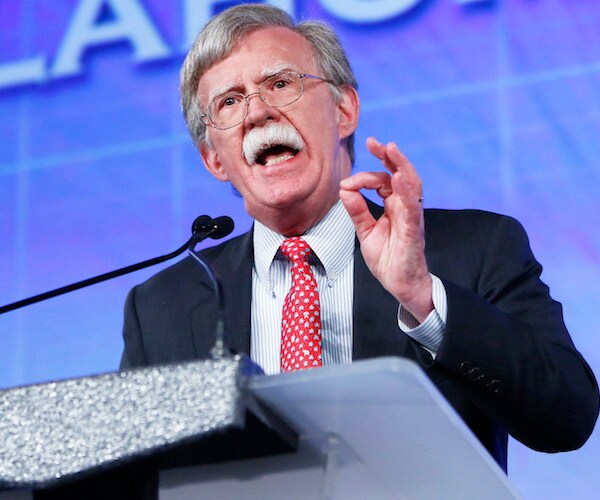 john bolton gestures and speaks during a conference speech