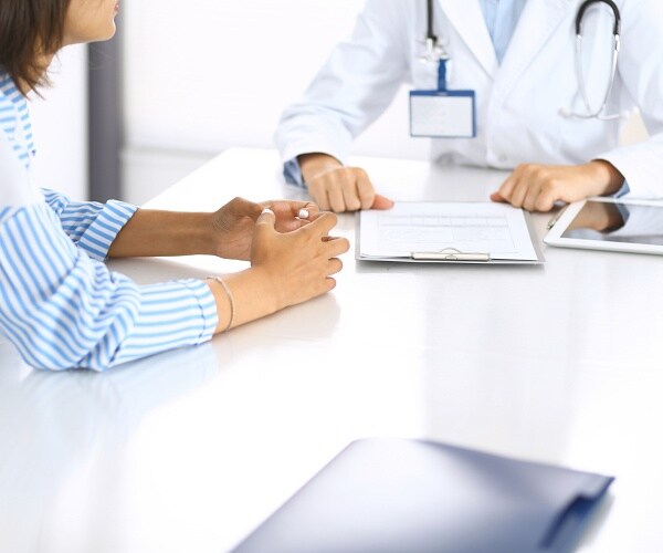 doctor and patient sitting at table
