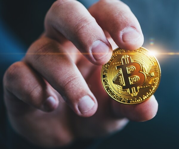 cryptocurrency golden bitcoin coin in man hand - symbol of crypto currency - electronic virtual money 